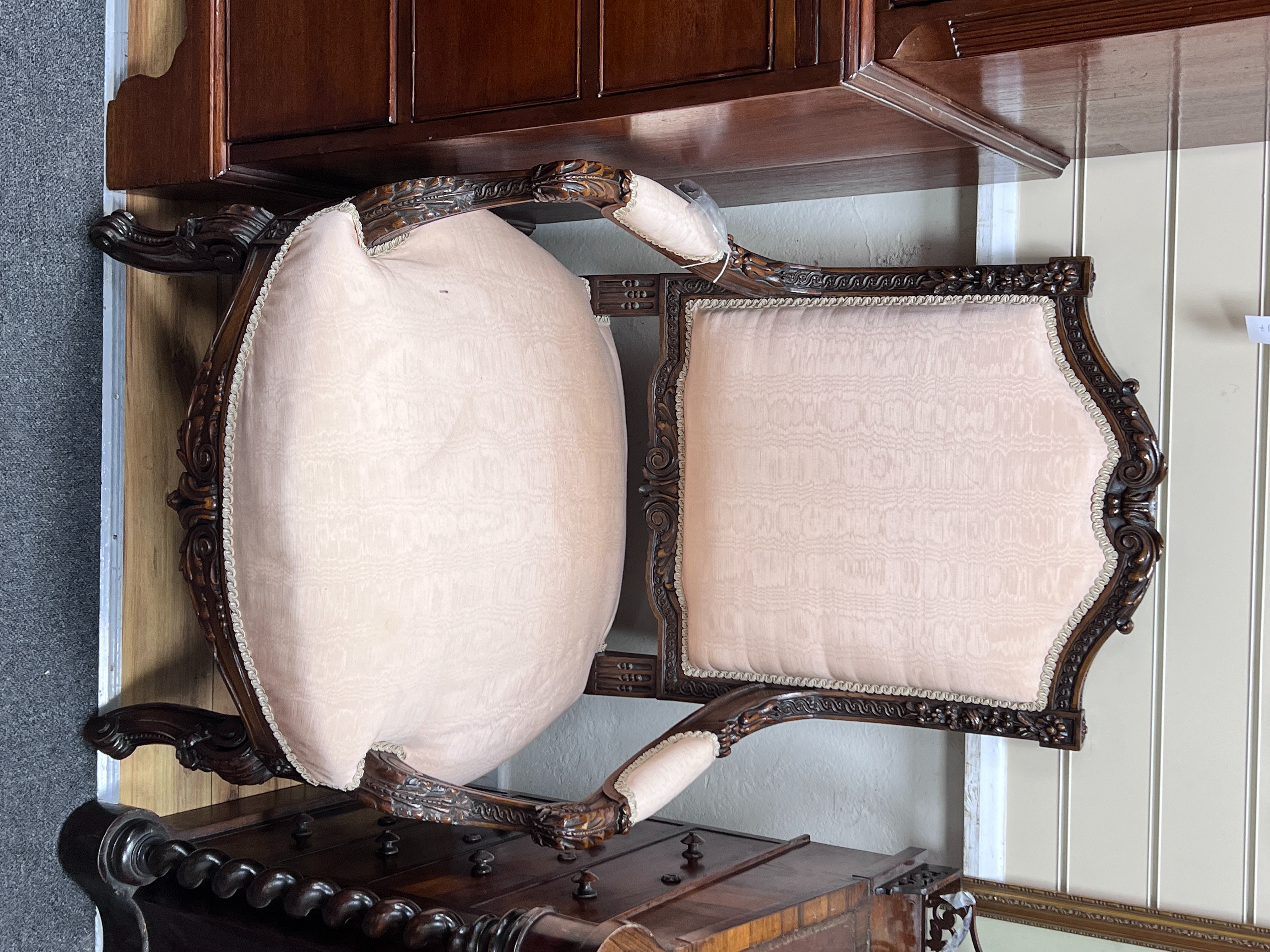 A pair of early 20th century carved walnut upholstered open armchairs, width 67cm, depth 57cm, height 107cm